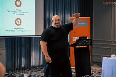 Kristian Livolsi On Stage at Momentum Growth School - Group Business Coaching Program